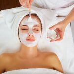 Woman in mask on face in spa beauty salon.